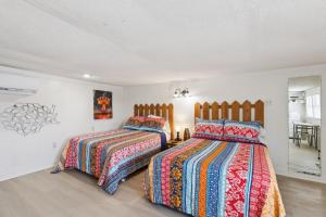 a bedroom with two beds and a dining room at Dave's Last Resort Poolside-Relaxing Cabin 3 Hotel Room in Monticello