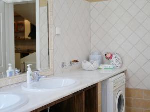 a bathroom with two sinks and a mirror at Villa Victoria Boutique Apartments in Sivota