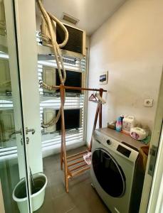 a kitchen with a washing machine and a window at Lush Lakeside - Citra Luxury Apartments in Jakarta