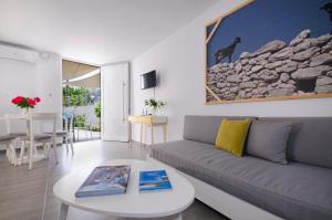 a living room with a couch and a table at Kallimento in Kissamos