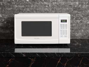 a white microwave sitting on top of a counter at Villa Rosa in San Felipe de Puerto Plata