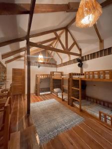 a room with bunk beds and a ceiling with beams at Balay Hayahay Clohaki Hostel in General Luna