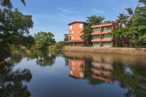 a building on the side of a river at Mandrem Beach Resort, a member of Radisson Individuals Retreat in Mandrem