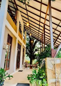 an outdoor patio with a wooden pergola at Vanaro Resort in Yala