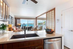 a kitchen with a sink and a view of the ocean at Incredible Ocean Views in Kailua-Kona