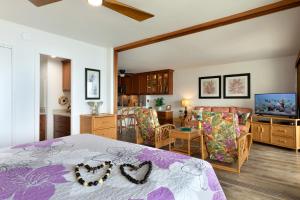 a bedroom with a bed and a living room at Incredible Ocean Views in Kailua-Kona +61 photos