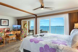 a bedroom with a bed and a view of the ocean at Incredible Ocean Views in Kailua-Kona