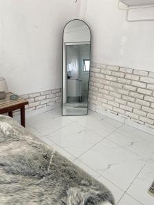 a room with a mirror and a bed and a table at Lakeside Studio Sleeps max 2 in Benoni +16 photos