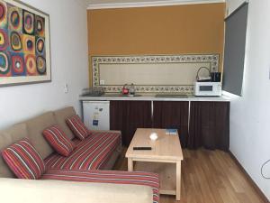 a living room with a couch and a table at Hostal Extramuros in Conil de la Frontera