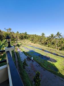 a view of a river from a balcony with a street light at Laras Homestay Munduk in Munduk