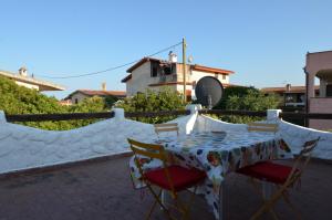 a table and chairs sitting on a patio at Fpo-Rose02p1 in Porto Ottiolu