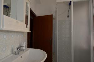 a bathroom with a sink and a mirror and a shower at Fpo-Rose02p1 in Porto Ottiolu +17 photos