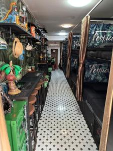 a room with a hallway with a room with a table at Tropical Vibes Hostel in Phi Phi Don