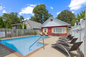 a swimming pool with chairs next to a house at Dave's Last Resort Lakeside-Comfy Cabin 5 Hotel Room in Monticello