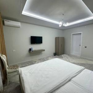 Ένα ή περισσότερα κρεβάτια σε δωμάτιο στο Boulevard Hotel Khiva