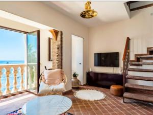 a living room with a view of the ocean at VitaLenta in Naxos in Giardini Naxos