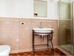 a bathroom with a sink and a shower and a toilet at VitaLenta in Naxos in Giardini Naxos +9 photos