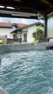 a close up of a pool of water with chairs at Villa Wie II in Niedernsill