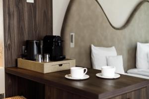 a coffee maker and two cups on a table in a hotel room at Notre Dame City Residence - Self Check-in in Nice