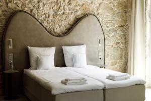 a hotel room with a bed with a large headboard at Notre Dame City Residence - Self Check-in in Nice