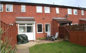 a red brick house with a white door and a patio at Shared Double Rooms in Buckinghamshire