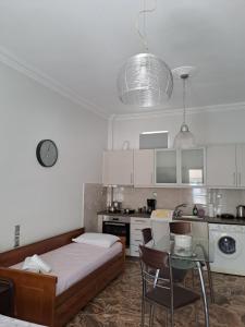 a kitchen with a bed and a table in a room at Sofia's apartment in Karistos