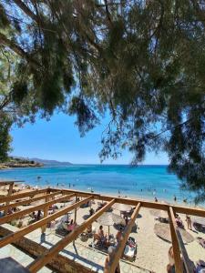 a view of a beach with people in the water at Sofia's apartment in Karistos