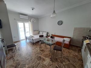 a living room with a table and a couch at Sofia's apartment in Karistos