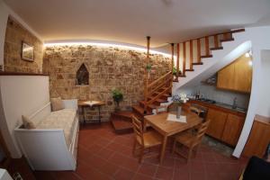 a kitchen and dining room with a stone wall at Casa Rustica in Conversano