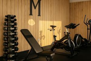 a gym with a treadmill and a bike in a room at Blue Marina Suites - Boutique Apartments in Arrecife