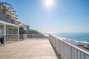 a balcony with a view of the ocean at 122 Camarque-Lavish lookout Penthouse in Umdloti