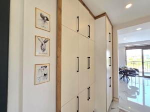 a pivot door in a hallway with pictures on the wall at odak turizm konutları 2 in Manavgat