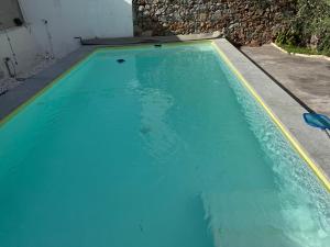a swimming pool with blue water in a house at La Casa de las Tias in Villanueva de Córdoba