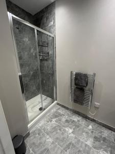 a bathroom with a shower with a glass door at Stylish apartment in Halifax in Halifax