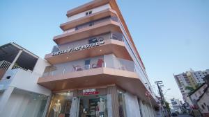 a building with a sign on the side of it at Davila Flat Hotel in Fortaleza