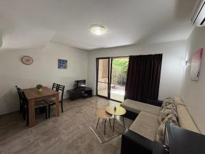 a living room with a couch and a table at The White Houses Complex in Nesebar