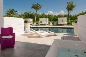 a villa with a swimming pool and a hot tub at Platinum Yucatan Princess Adults Only - All Inclusive in Playa del Carmen