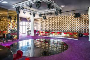 a room with a purple floor and a large wall of wine barrels at Platinum Yucatan Princess Adults Only - All Inclusive in Playa del Carmen +58 photos