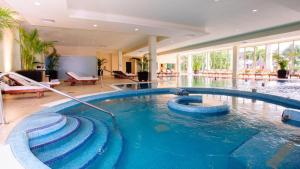 a swimming pool in a building with a swimming pool at Grand Riviera Princess - All Inclusive in Playa del Carmen +82 photos