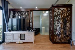 a bathroom with a white cabinet and a mirror at Riverside Hotel Đông Anh in Dong Anh