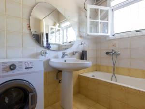 a bathroom with a sink and a washing machine at Liakos' Apartments in Vasiliká +123 photos