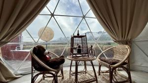 a room with chairs and a table in front of a window at ปัวเดอะมูน in Ban Fang