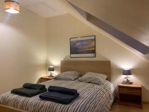 a bedroom with a bed with two pillows on it at Maison duplex centre plage port cabine in Le Crotoy