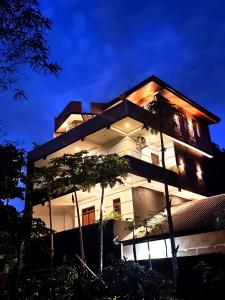 a building at night with lights on at Black Pearl Apartments - with free snorkeling Mirissa in Mirissa