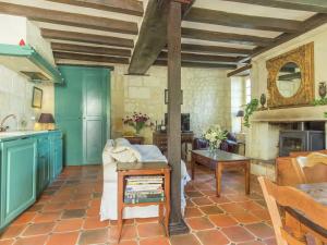 a kitchen with blue cabinets and a table at Riverside Hideaway in Cinais in La Roche-Clermault +33 photos