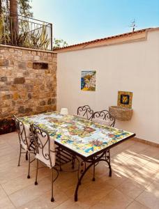 a table and chairs sitting on a patio at Villa Le Favole in Sant'Egidio del Monte Albino