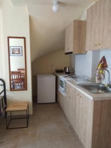a kitchen with a sink and a counter top at Jenny's House in Skiathos Town