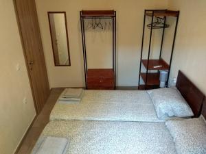 a bedroom with two beds and two mirrors at Jenny's House in Skiathos