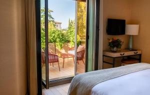 Un dormitorio con una cama y un balcón con televisión. en Starhotels Michelangelo Florence, en Florencia