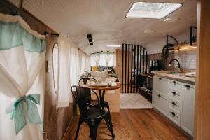 a kitchen and dining room with a table and chairs at Explore Motorhome in Domingos Martins